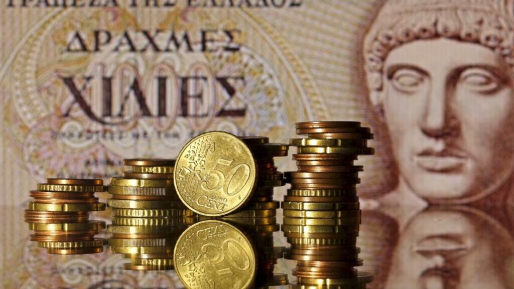 Euro coins are seen in front of an  old Greek drachma   banknote: what would  be the terms of a Greek exit –  would it crash out of the euro zone and default on most of its liabilities, or would there be some kind of more managed process with some ongoing European or IMF support?   Photograph: Dado Ruvic/Reuters