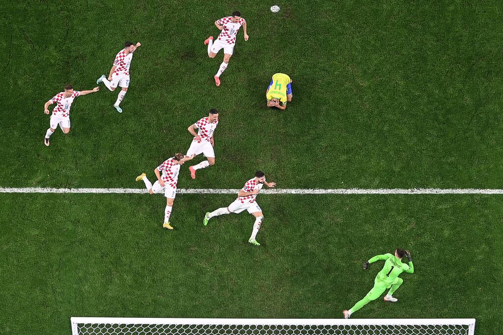 Croatia players celebrate after Brazil's Marquinhos hit the post with his penalty during the World Cup quarter-final penalty shoot-out at Education City Stadium. Photograph: Anne-Christine Poujoulat/AFP via Getty Images