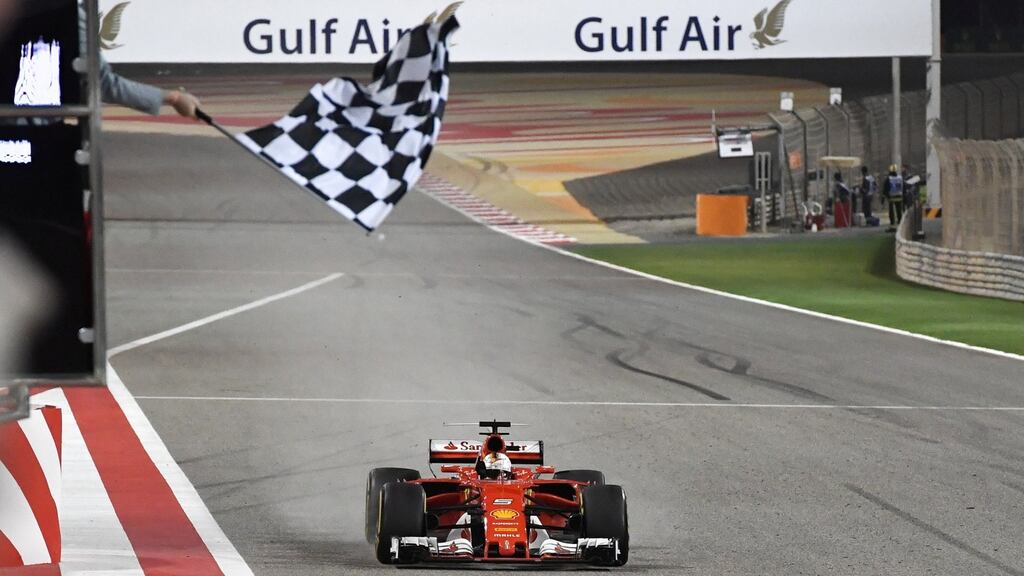 Ferrari’s Sebastian Vettel takes the chequered flag to win the Bahrain Formula One Grand Prix. Photograph: Andrej Isakovic/Reuters