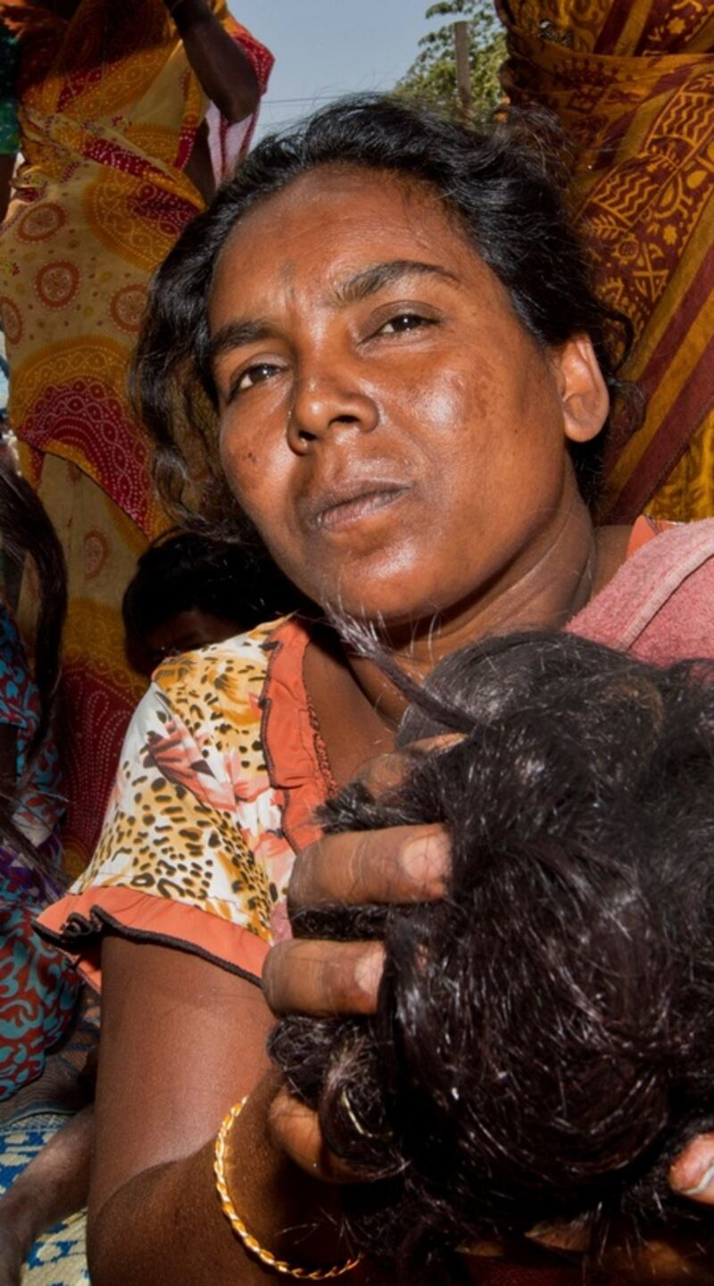 Gangamma sorts human hair in the TC Palya slum in Bangalore, in India, to be sold for use in wigs and hair extensions in the salons of the West. Photograph: Brenda Fitzsimons