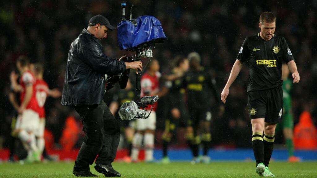 Wigan Athletic’s James McCarthy walks off dejected after his side were relegated at the Emirates Stadium. Photograph: Stephen Pond/PA Wire