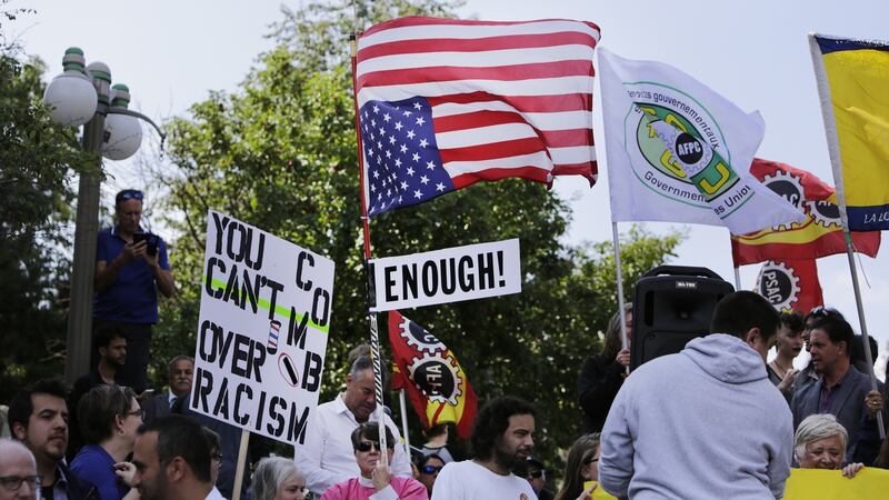 A demonstrator carries an upside down American flag during an anti-racism rally in front of the US Embassy in Ottawa, Ontario, Canada on Thursday. Photograph: David Kawai/Bloomberg