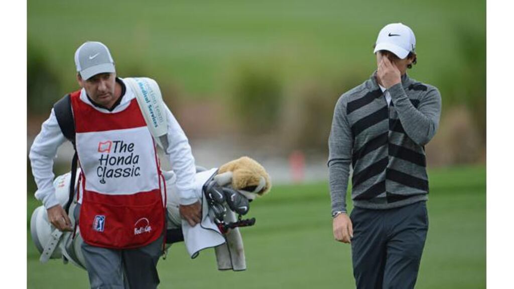 World number one Rory McIlroy walks off the course with caddie JP Fitzgerald during the second round of the Honda Classic in Palm Beach Gardens, Florida. McIlroy later said severe pain from a wisdom tooth had forced him to abandon the round. Photograph: Stuart Franklin/Getty Images