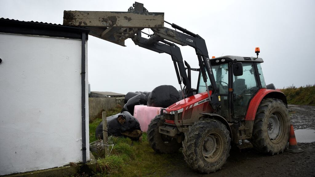 A tractor is positioned to hold a roof down on a farm as as Ophelia hits the Co Clare peninsula of Loop Head. Photograph: Clodagh Kilcoyne/Reuters