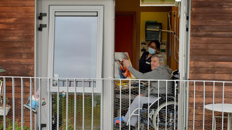 Eamon Hughes, a resident of Teach Íosa, one of the community units at St Mary’s Hospital in Phoenix Park, painting one of the deer who visit outside his bedroom window, and healthcare worker Cecilia Roque. Photograph: Alan Betson/The Irish Times