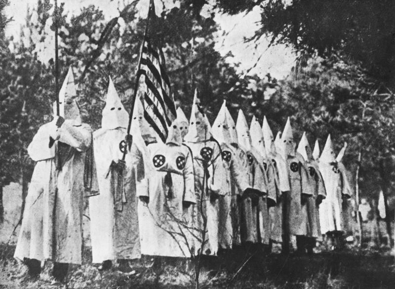 Ku Klux Klan members, circa 1930, with US flag. Photograph: Henry Guttmann Collection/Hulton Archive/Getty