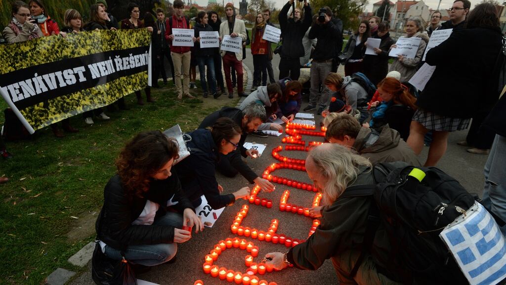 Protesters show their solidarity with migrants detained in Czech refugee detention centres in Prague last November. The Czech government had backed a scheme run by church groups to resettle Christians driven from their homes by extremist organisations like Islamic State. Photograph: Michal Cizek/AFP/Getty Images