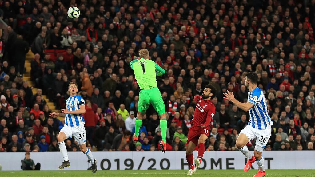Liverpool’s Mohamed Salah scores his side’s third goal during the Premier League match against Huddersfield Town at Anfield. Photograph: Peter Byrne/PA Wire