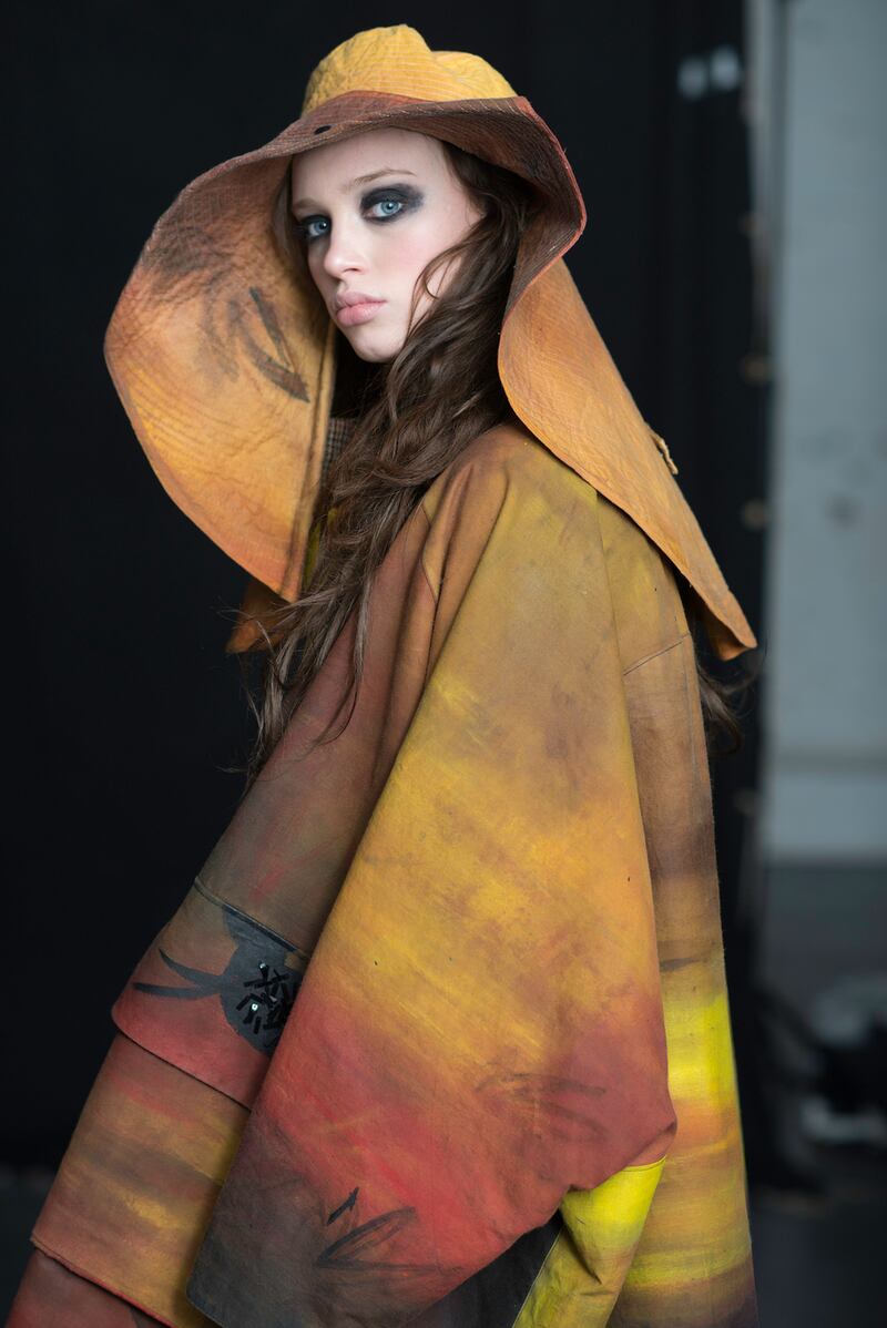 Hand-painted waxed-cotton hunter coat €850, wide-brim shelter hat €550, autumn leaves trouser €200, knit neckpiece €50