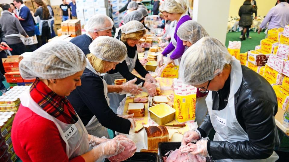 Volunteers preparing food and goody bags for distribution at the annual Christmas Dinner, organised by the Knights of St Columbanus, in partnership with the members of the Royal Dublin Society. Photograph: Eric Luke