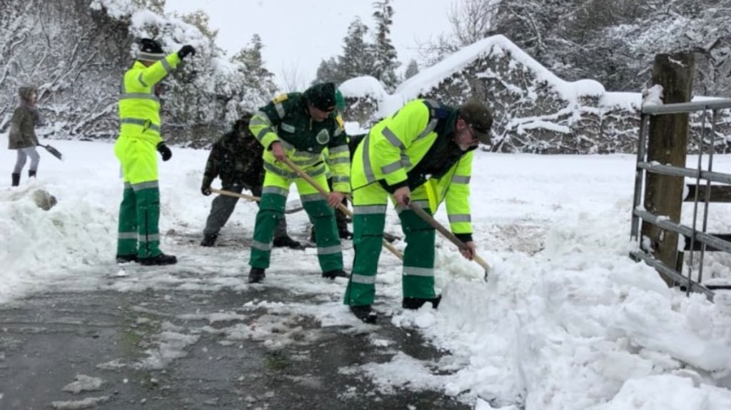 Ambulance workers digging snow blocking Naas ambulance station.
