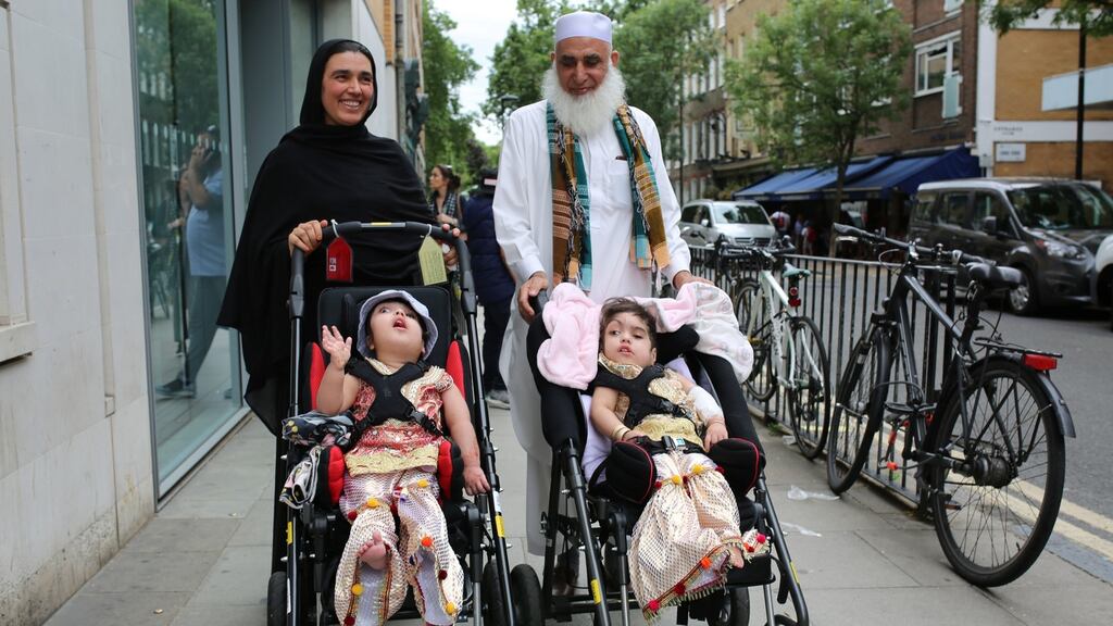 Two-year-olds Safa and Marwa Ullah, from Charsadda in Pakistan, leaving hospital after a surgery to separate their heads at the hospital in London, with their mother Zainab Bibi and their grandfather Mohammad Sadat. Photograph: Great Ormond Street Hospital/PA