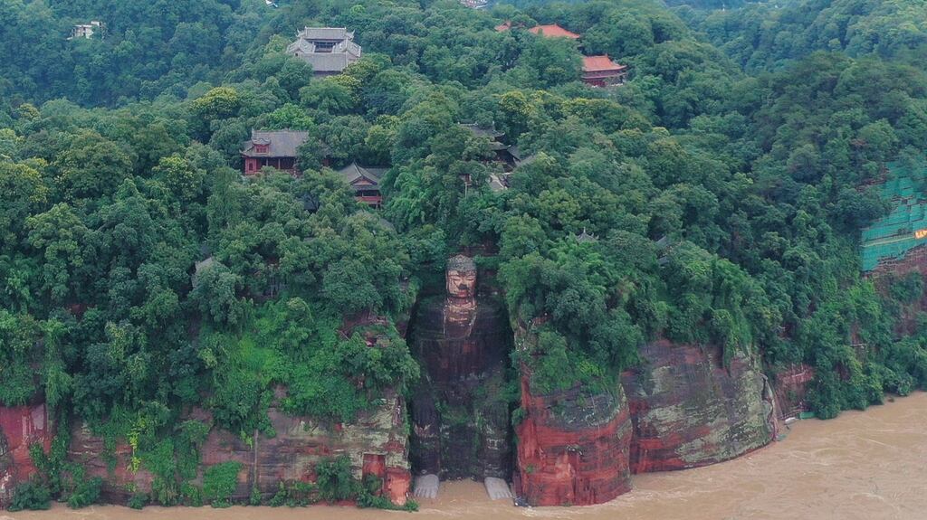 Flootwaters reach the feet of the Leshan Giant Buddha, a world heritage site, following heavy rainfall in Sichuan province, China. Photograph: EPA/Li Xinfeng