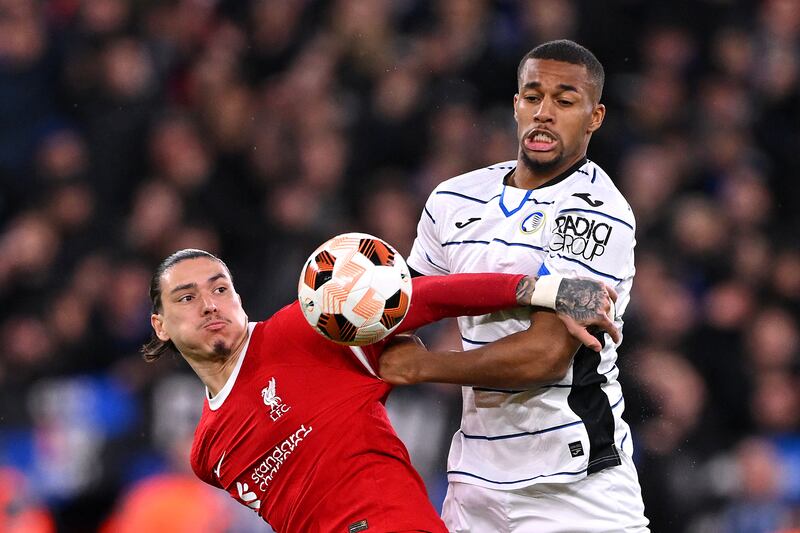 Darwin Nunez of Liverpool and Isak Hien of Atalanta BC battle for the ball. Photograph: Stu Forster/Getty