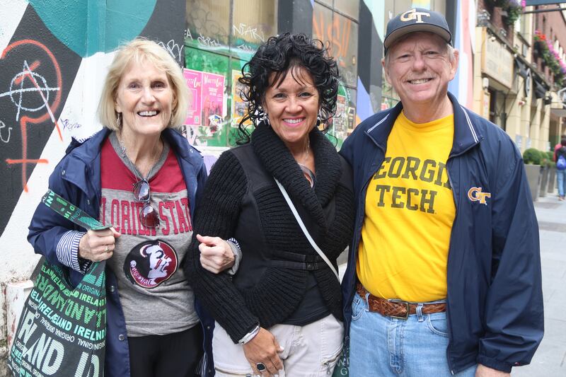 From left, Pamela Miner, Esther Smith and Mark Smith in Temple Bar before the Aer Lingus College Classic in the Aviva Stadium. Photograph: Ronan McGreevy