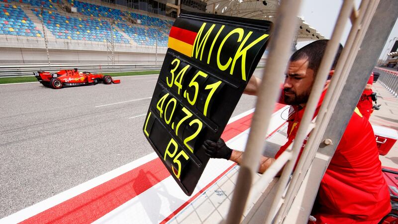 A Ferrari mechanic shows the time board to Mick Schumacher during his first testing for the Formula One team at the Bahrain International Circuit. Photograph: Valdrin Xhemaj/EPA