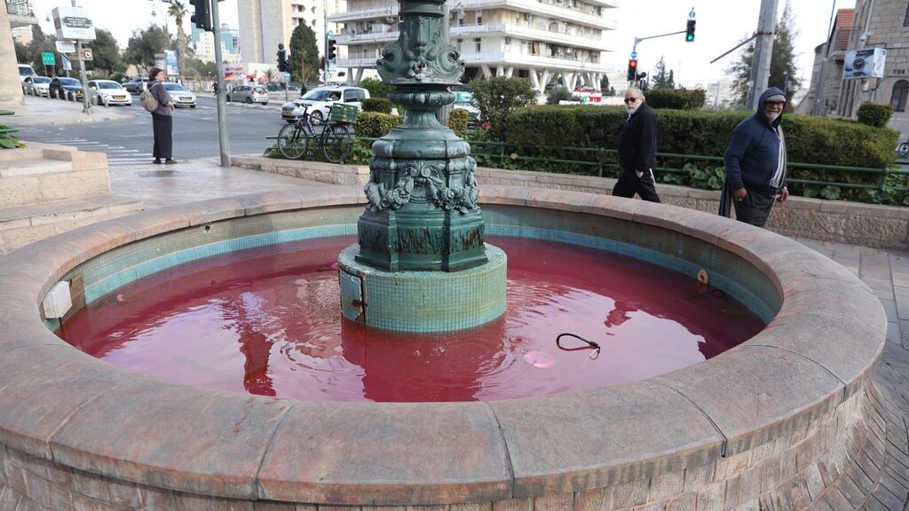 The fountain in France (Paris) Square in Jerusalem is turned red by activists as part of a violence against women national protest in Israel. Photograph: Abir Sultan/EPA