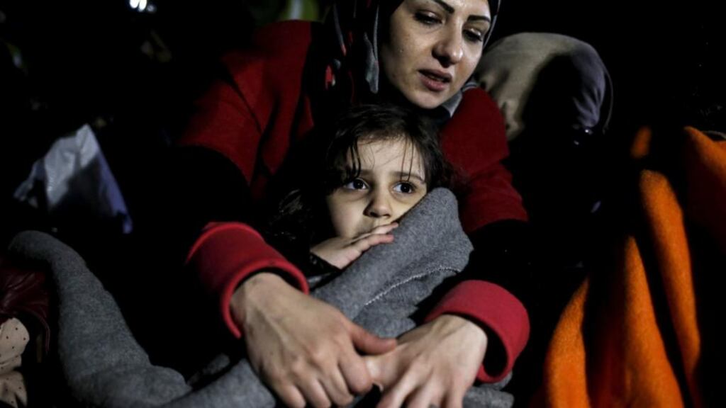 A girl is covered with a blanket as refugees and migrants arrive on a dinghy on the shore near the city of Mytilene on the Greek island of Lesbos on Monday, despite an EU-Turkey plan to send migrants arriving in Greece back to Turkey. PhotographL Alkis Konstantinidis/Reuters