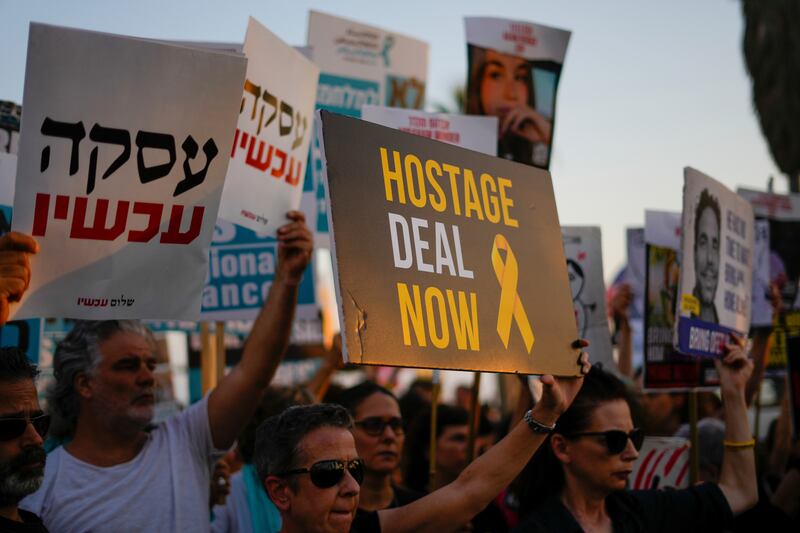 Protesters wave signs in Tel Aviv calling for the release of hostages from Hamas captivity in the Gaza Strip. Photograph: Ariel Schalit/AP