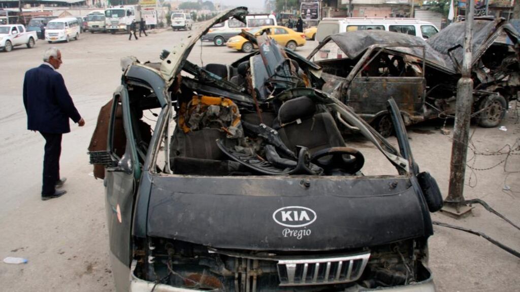 A man walks past the site of a bomb attack in Baghdad’s Sadr City earlier this week. Nineteen people were killed in another attack today. Photograph: Reuters