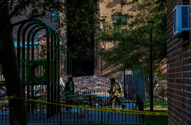 Firefighters work near the site of a building collapse in the Bronx borough of New York. Photograph: Eduardo Munoz Alvarez/ AP