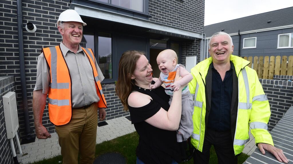 Helen Cheevers with her baby Erik outside their home in Ballymun, with Hugh Brennan of Ó Cualann cohousing alliance and architect Joe Kennedy. Photograph: Cyril Byrne
