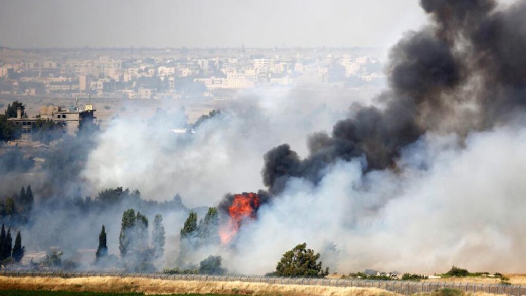 Smoke rises as a fire burns near the Kuneitra border crossing, as seen from the Israeli occupied Golan Heights, close to the ceasefire line between Israel and Syria. Photograph: Ammar Awad/Reuters