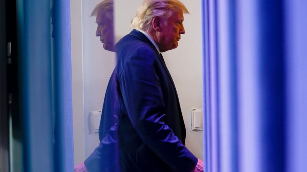 US president Donald Trump leaves a news conference in the White House on Friday. Photograph: AP