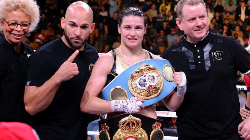 Katie Taylor celebrates her victory with her team. Photograph: Emily Harney/Inpho