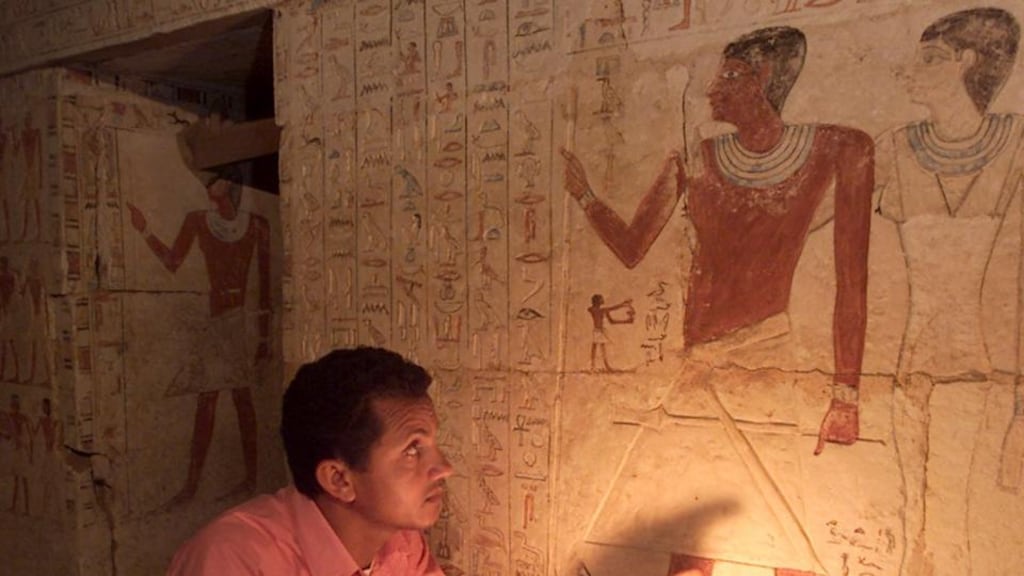 An Egyptian antiquities expert examines hieroglyphics in a tomb near Sakkara in Egypt in 2003. On Sunday, archeologists discovered a tomb in Abu Sir of a previously unknown queen who ruled 4,500 years ago. Photograph: Aladin Abdel Naby/Reuters.