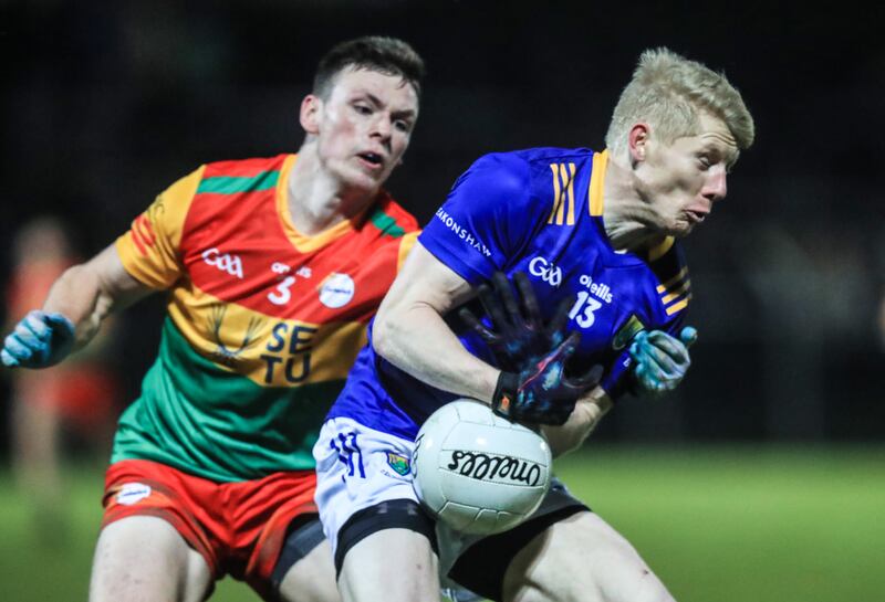 Wicklow's Mark Kenny up against Carlow's Mikey Bambrick at Netwatch Cullen Park, Carlow. Photograph: Evan Treacy/Inpho