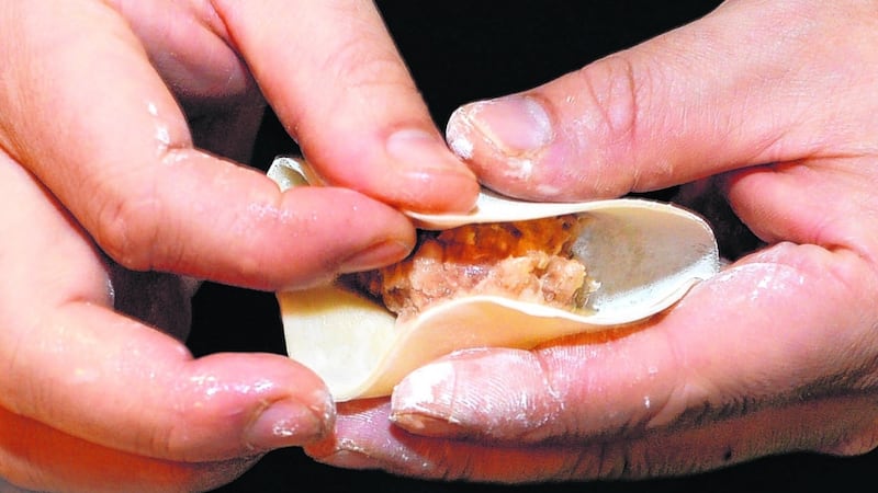 Kwanghi Chan demonstrating how to make a potsticker dumpling. Photographs: Dara Mac Dónaill