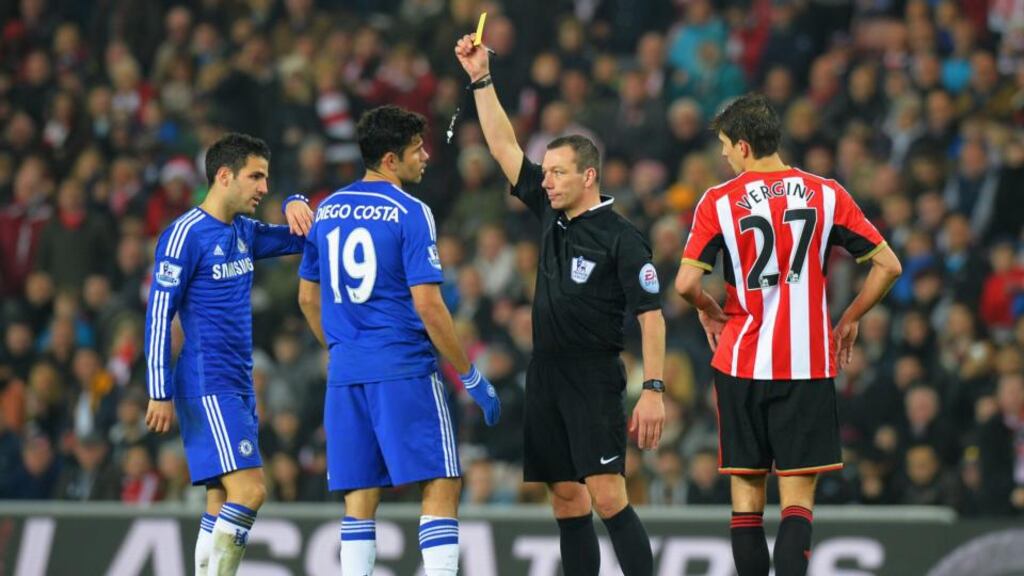 Referee Kevin Friend shows a yellow card to Diego Costa of Chelsea after a clash with Sunderland’s Wes Brown during the Premier League match at the Stadium of Light. Photograph: Tony Marshall/Getty Images