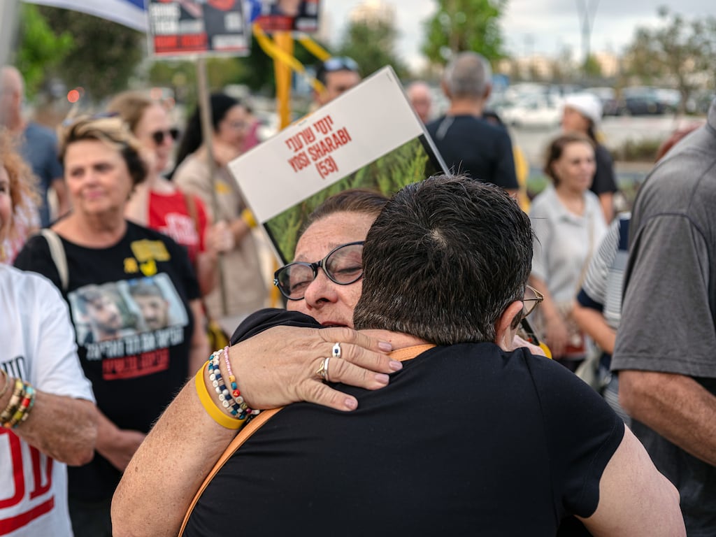 Sylvia Cunio, mother of hostages Ariel and David Cunio, is embraced by a supporter during a demonstration on Thursday. Photograph: New York Times