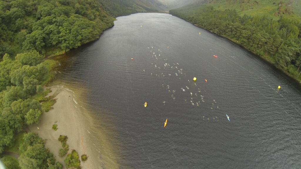 Swimmers and support kayaks in Glendalough, Co Wicklow