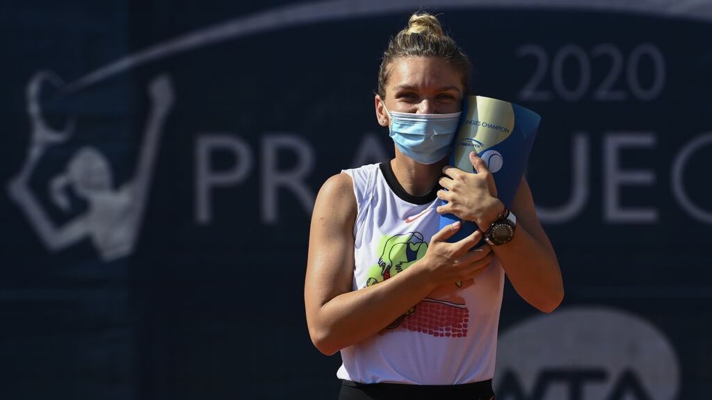 Simona Halep celebrates with the trophy after winning the Prague Open. “I always said I would put my health at the heart of my decision and I therefore prefer to stay and train in Europe.” Photograph: Martin Sidorjak/Getty Images