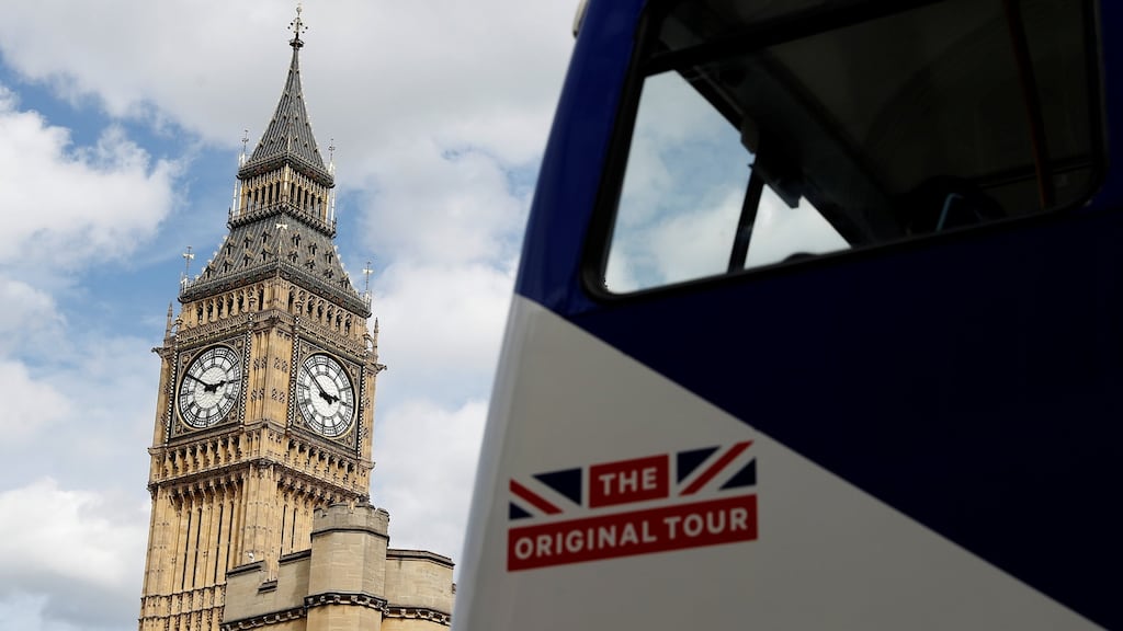 A tourist bus passes the Queen Elizabeth Tower, which houses the Great Clock and the ‘Big Ben’ bell, at the Houses of Parliament in London. Photograph:  Peter Nicholls/Reuters