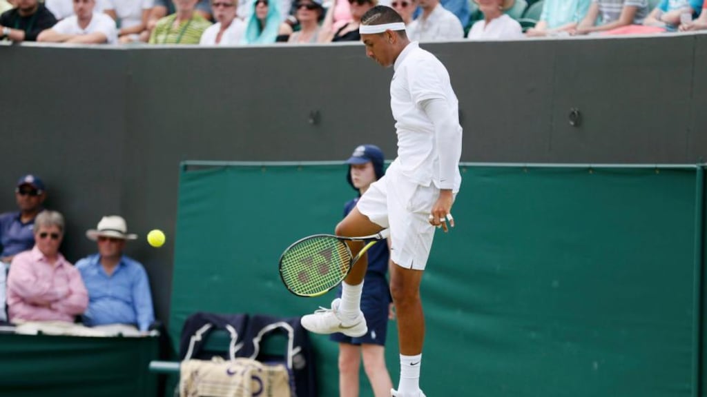 Nick Kyrgios of Australia hits a shot through his legs during his match against Milos Raonic of Canada at Wimbledon. Stefan Wermuth/Reuters