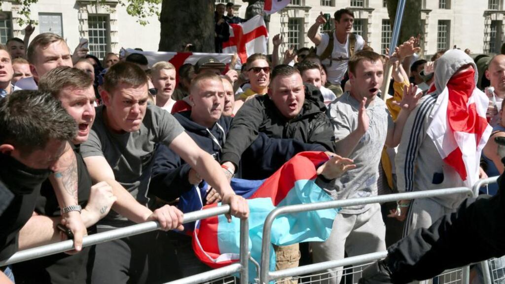 English Defence League (EDL) supporters try to reach anti-fascist protestors during a rally outside Downing Street in London today. Photograph: Peter Macdiarmid/Getty Images