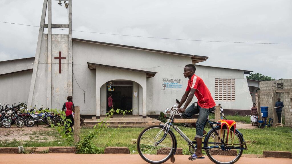A man drives his bike taxi past the Church of Christ during Pentecost celebrations on Sunday in Mbandaka, northwest of DR Congo. Photograph: Junior D Kannah/AFP/Getty Images