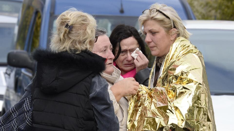 Emergency services personnel take away an injured person from the site of a collision in Puisseguin, near Libourne, southwestern France. Photograph: AFP