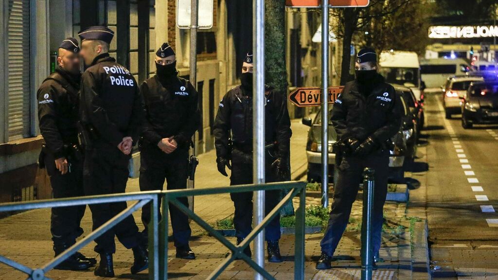 Police officers conduct new searches linked to Paris terrorist attacks, on Thursday in Molenbeek, in Brussels. Photograph: AFP