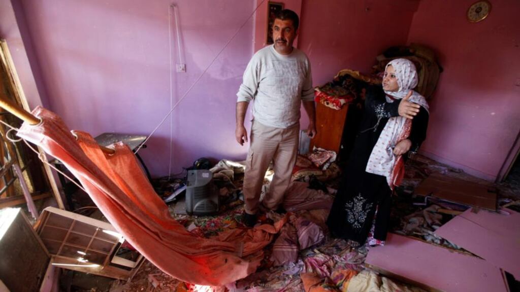 Iraqis examine damage inflicted on their house by a car bomb attack in AL-Mashtal district in Baghdad last Tuesday. Car bombs and a suicide blast hit Shi'ite districts of Baghdad and south of Iraq’s capital, killing at least 50 people on the 10th anniversary of the invasion that ousted Saddam Hussein. REUTERS/Mohammed Ameen