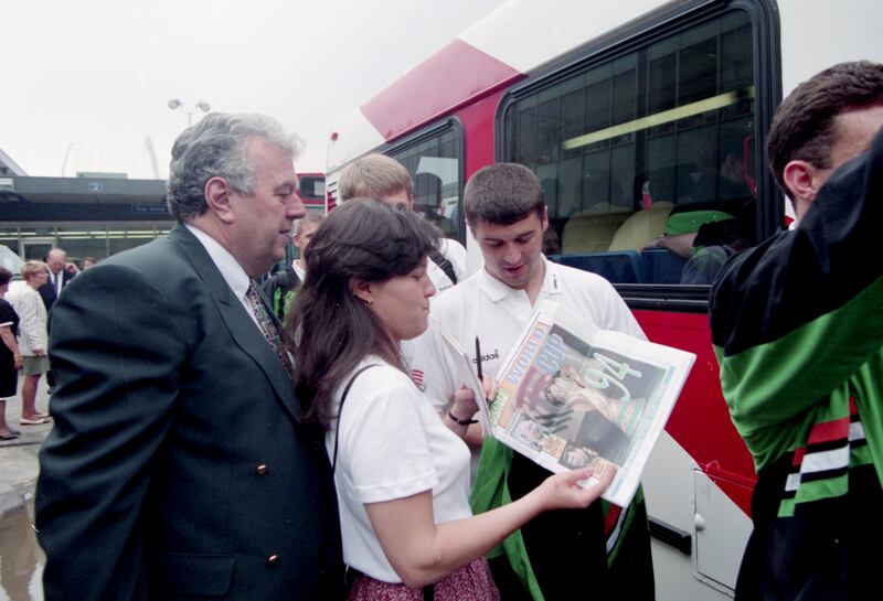Joe Delaney watches on as Roy Keane signs autographs for fans in Orlando, Florida during the 1994 World Cup. Photograph: Billy Stickland/Inpho