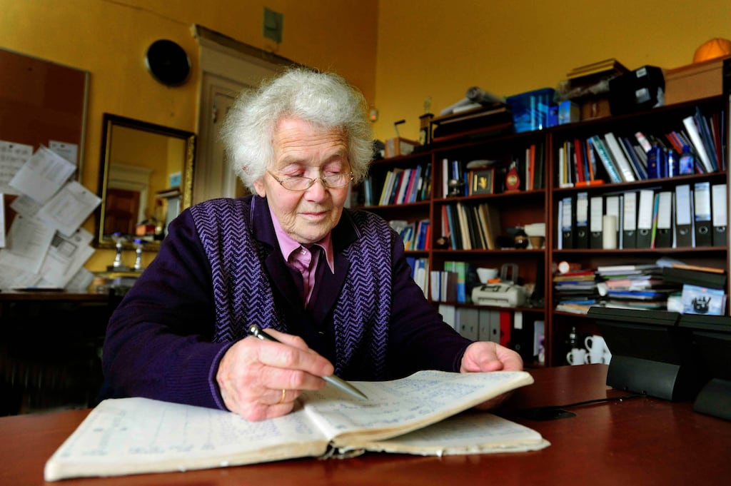 Mary O'Donovan co-founder of Scoil Mhuire, looking through an old school register. Photograph: Denis Scannell