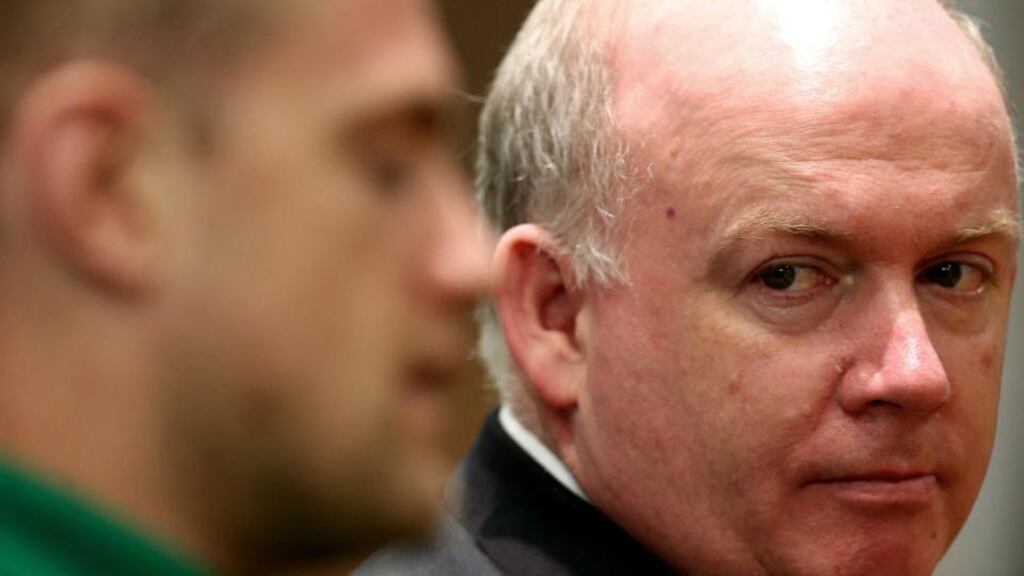 Ireland coach Declan Kidney looks on as captain Jamie Heaslip talks during the post-match press conference in Rome. Photograph: James Crombie/Inpho
