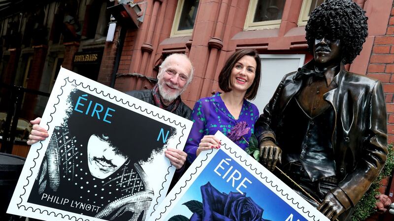 Artist Jim Fitzpatrick and An Post chief of staff Aoife Beirne at the Phil Lynott statue in Dublin off Grafton Street. Photograph: Maxwell