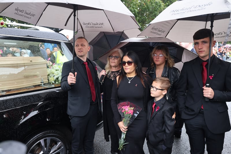 Christy Dignam's wife Kathryn, daughter Kiera, her husband Darren and their children Cian, Ava and Jake, at the farewell gathering on Farnham Drive, Finglas. Photograph: Dara Mac Dónaill