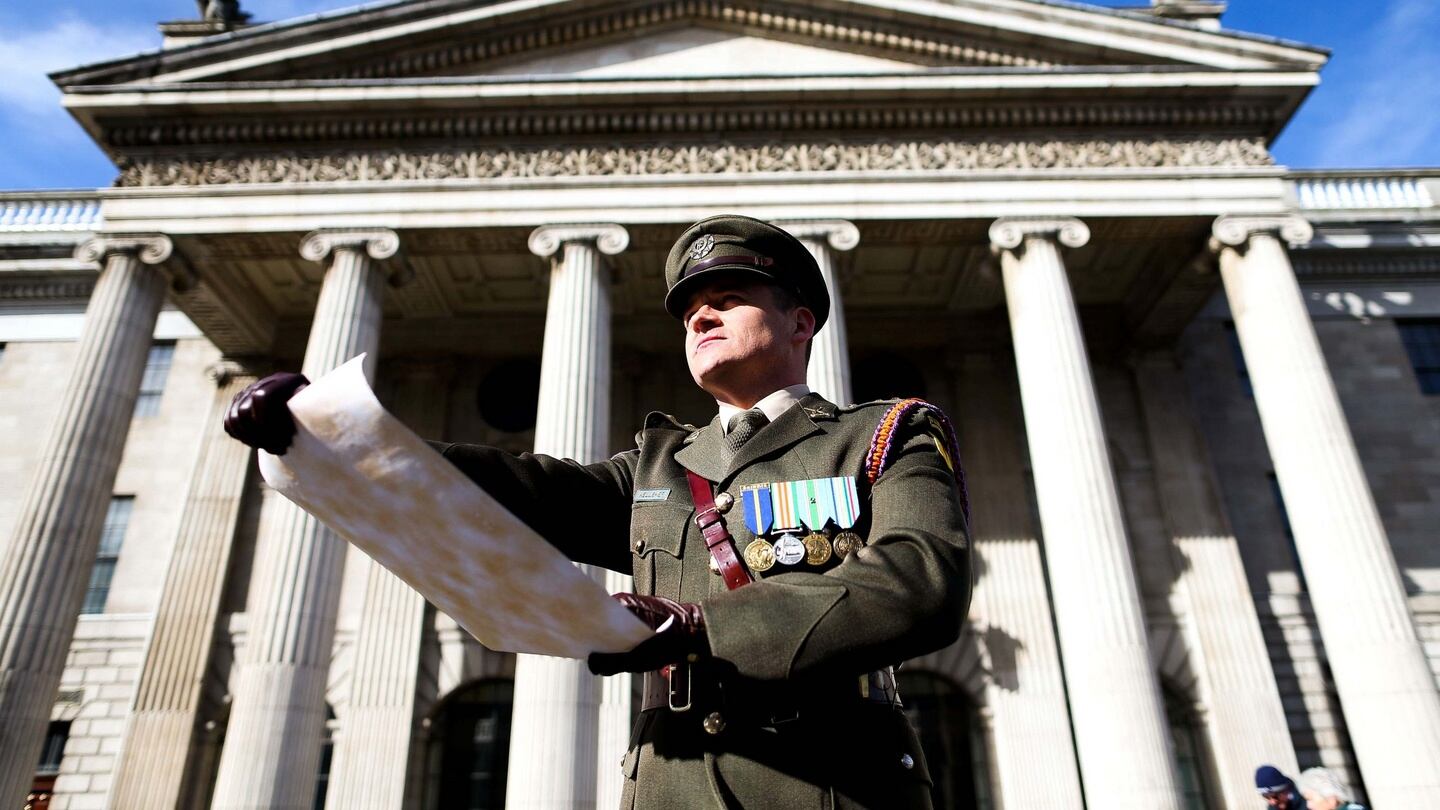 Captain Peter Kelleher from the 27th Infantry Battalion, reading the Proclamation at the GPO. Photograph: Maxwells/PA Wire/Handout