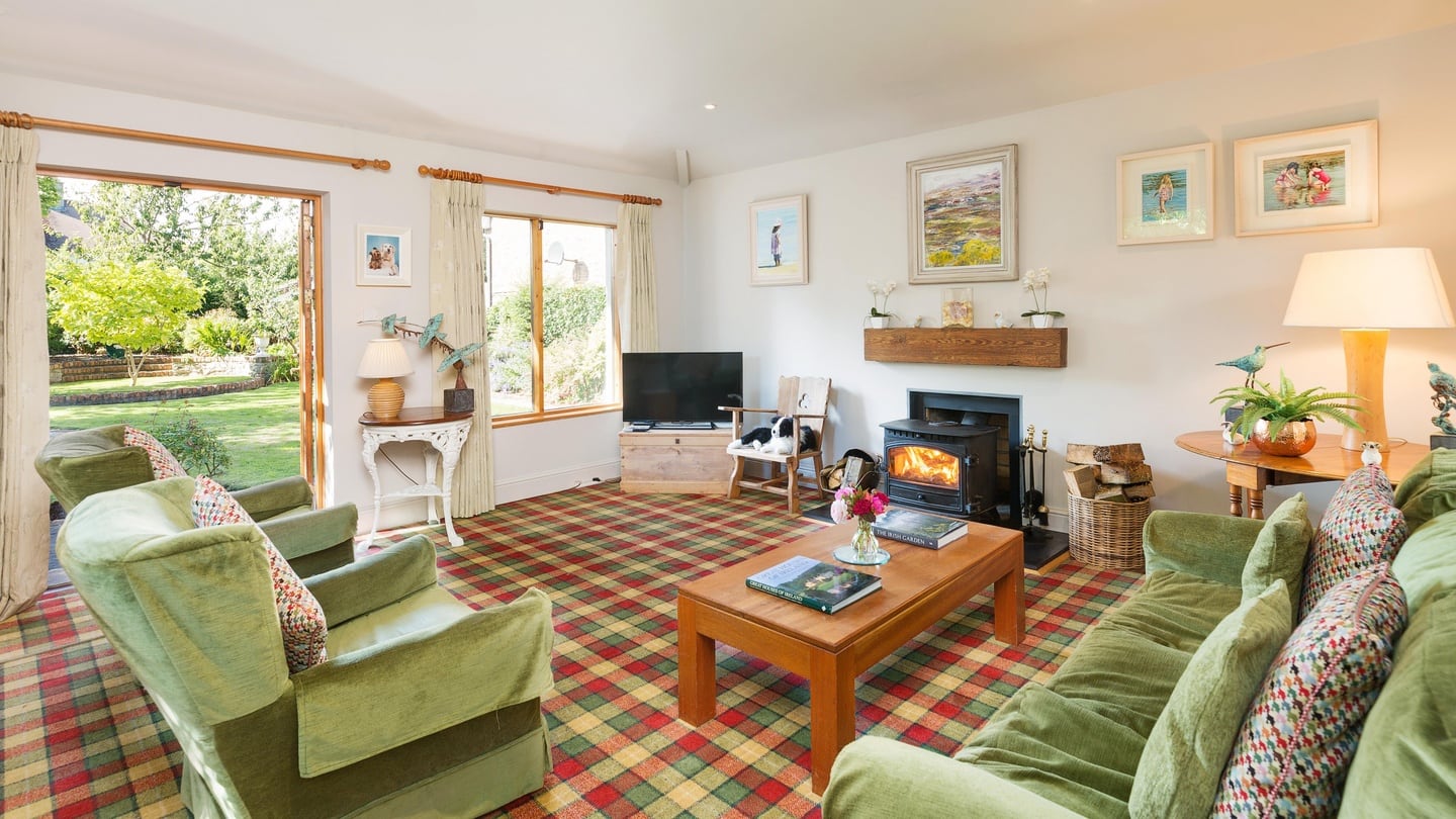 A family room with solid fuel stove overlooks and makes the most of the rear garden.